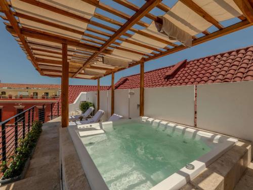 a hot tub on a patio with a pergola at Hotel Boutique Bovedas de Santa Clara By Accor in Cartagena de Indias