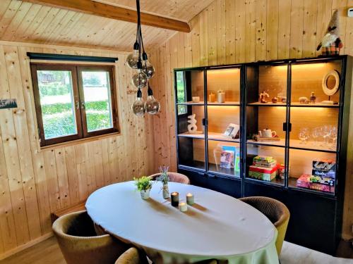 a dining room with a white table and chairs at Chalet La Roche 231 in Rendeux