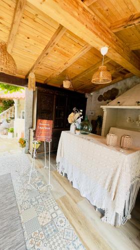a room with a large white table in a house at Casa Susa in Poio