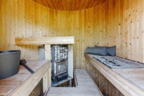 a wooden cabin with a fireplace in it at Villa Veneskoski in Veneskoski