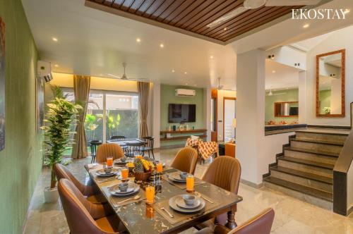 a dining room with a table and chairs at EKOSTAY - Casa Elara in Igatpuri