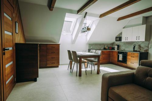 a kitchen and dining room with a table and chairs at Apartament CEKO 2 in Ostrowsko