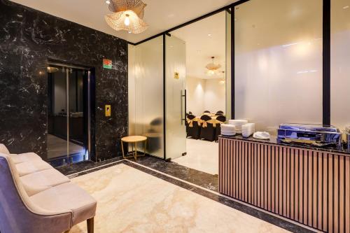 a salon with a chair and a waiting room at Airport Premier In With Free Airport Drop in New Delhi