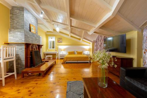 a living room with a bed and a fireplace at Johnson Lodge Manali in Manāli