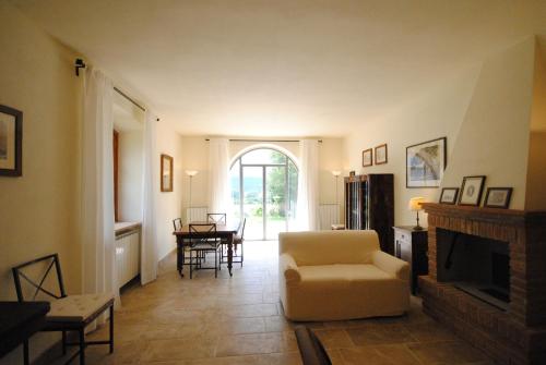 a living room with a chair and a fireplace at Agriturismo I Gergoni in Monteleone dʼOrvieto