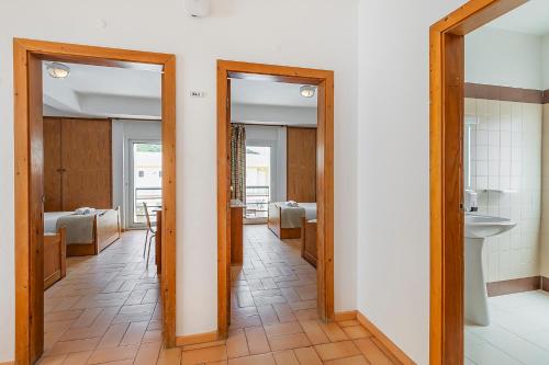 a hallway with two doors leading to a bathroom at HI Alcoutim – Pousada de Juventude in Alcoutim