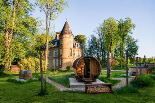 an old house with a igloo in the yard at Private Château with sauna, hot tub & 4ha park - Château Guillermo in La Moncelle