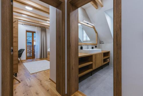a bathroom with a sink and a mirror at Alpine HOUSE 77 in Kranjska Gora