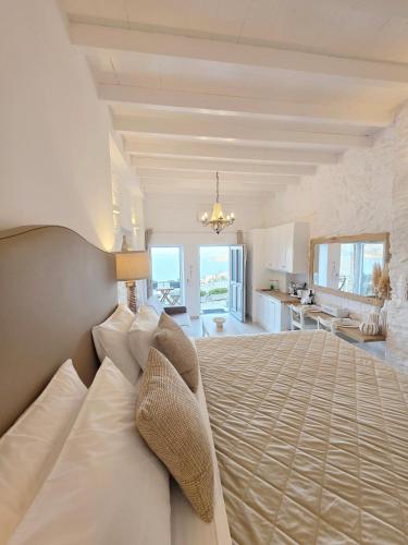 a large bedroom with a bed and a kitchen at TOP SUITES in Ermoupoli