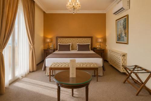 a hotel room with a bed and a table at Acropole Tunis in Tunis