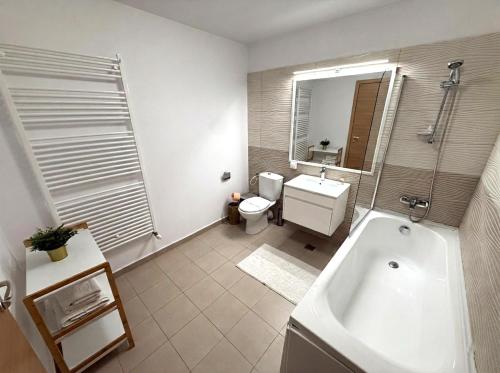a bathroom with a tub and a toilet and a sink at Negru Voda 9- Old Town in Constanţa