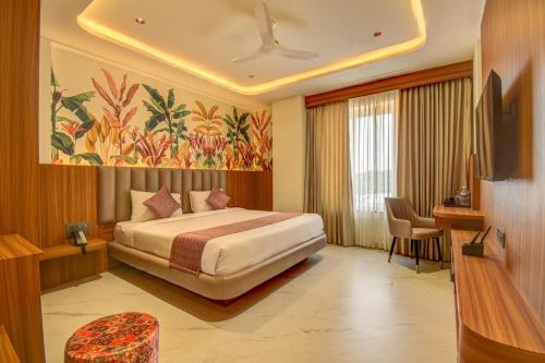 a hotel room with a bed and a television at The White Castle Hotel in Mysore
