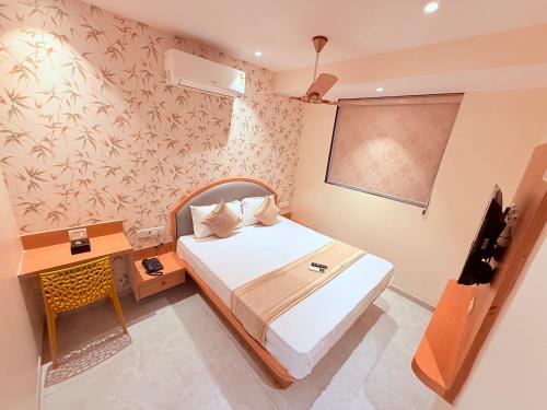 a bedroom with a bed and a desk and a chalkboard at Hotel Radhe Residency Taloja MIDC - Only accomodate Indian citizens in Panvel