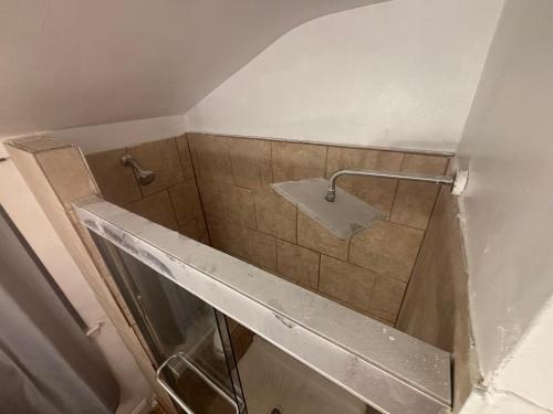 a bathroom with a tiled shower with a sink at Peace & Relax sensation in Washington, D.C.