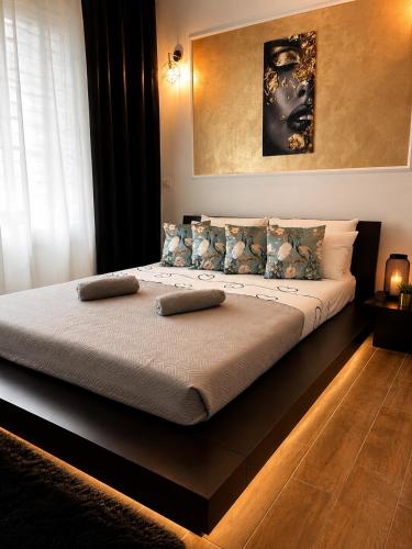 a bed with two pillows on it in a bedroom at Rebecca's Noir Suite in Reggio Emilia
