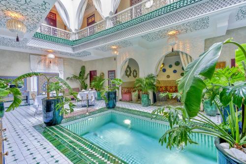 a large indoor pool with plants in a building at Riad Samir Oasis And Spa in Marrakesh