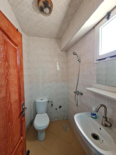 a bathroom with a toilet and a sink at Banana Aourir in Aourir