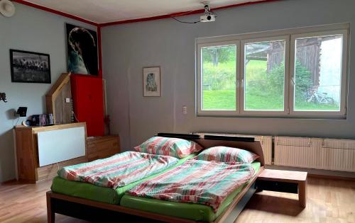 a bedroom with a bed and a window at Apartment Rappitsch in Sankt Marein bei Knittelfeld