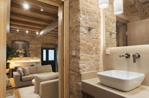 a bathroom with a large white sink in a room at Arco Segreto Apartment, Old Town in Corfu