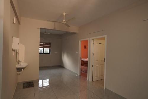 a bathroom with a sink and a ceiling fan at Blue Pearl Residency in Trivandrum