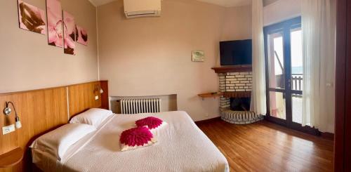 a bedroom with a bed with a red flower on it at Ca Vecia in Gargnano