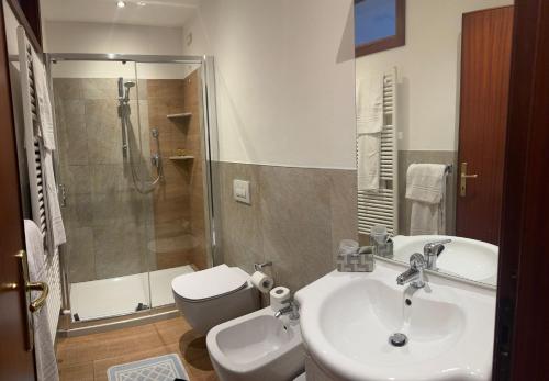 a bathroom with a sink and a toilet and a shower at Ca Vecia in Gargnano