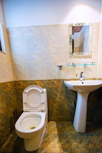 a bathroom with a toilet and a sink at Rameshworam Hotel in Kathmandu