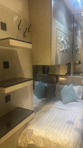 a bedroom with a large bed with white sheets at Transit Room in Riyadh