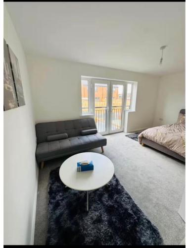 a living room with a couch and a table at Ansari House in Dummer