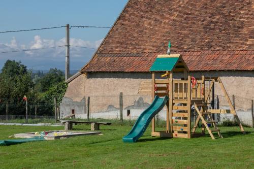 a playground with a slide and a slideintend at La Maison Bornat in Versaugues