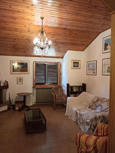 a bedroom with a bed and a chandelier at Carpineti Republic in Monterone