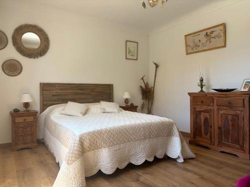 a bedroom with a bed and two dressers and a mirror at Maison 5mn de la mer in Fréjus