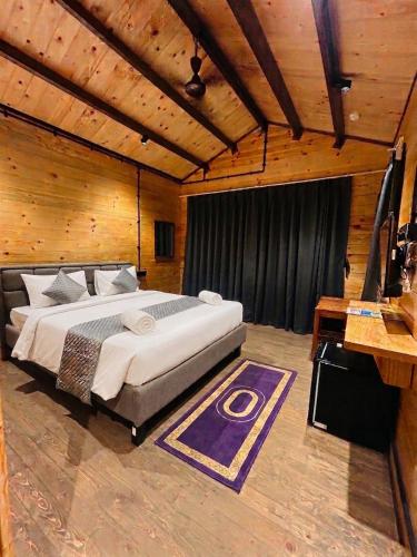 a bedroom with a large bed in a room at Seclude Eco Cottages in Anjuna