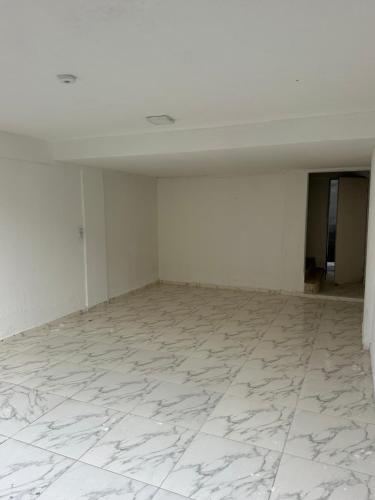an empty room with white walls and a white tile floor at Villa Marechais in Marechal Deodoro