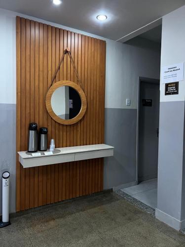 a mirror on the wall of a bathroom at Carmo Palace Hotel in Carmo do Paranaíba