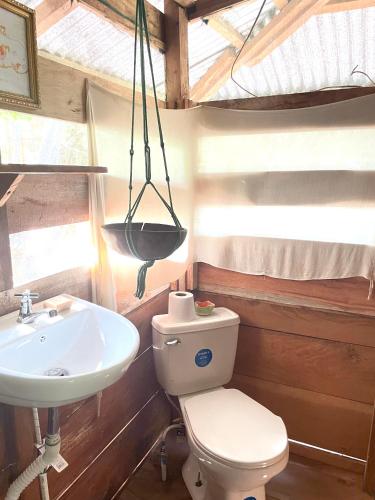 a bathroom with a toilet and a sink at Cedar Loft in Las Pilas