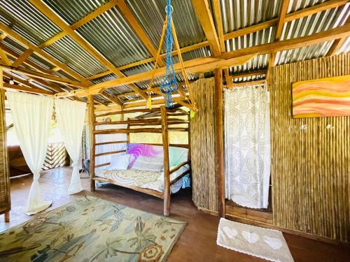 a bedroom with a bed in a room with a ceiling at Cedar Loft in Las Pilas