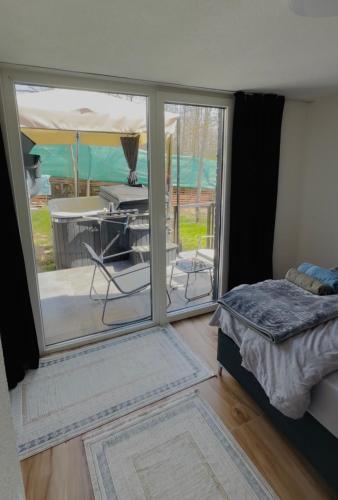 a bedroom with a sliding glass door with a patio at Villa Dielli Gadish in Gnjilane