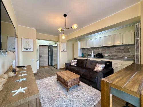 a living room with a couch and a table at C&Y Zev Apartments in Mamaia
