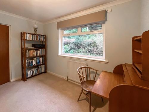 a home office with a desk and a window at Creag Bheag in Appin