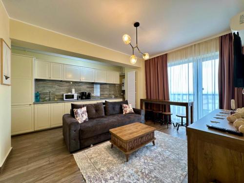 a living room with a couch and a table at C&Y Zev Apartments in Mamaia
