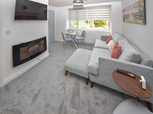 a living room with a couch and a fireplace at Old Chapel Apartment in Kendal