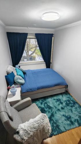 a bedroom with a bed and a couch and a window at Sun in Närpiö