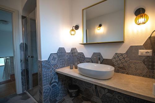 a bathroom with a sink and a mirror at Villa Rosa in Budoni