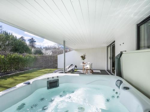 a bath tub in the backyard of a house at Little Dunley Cottages - Willow in Bovey Tracey