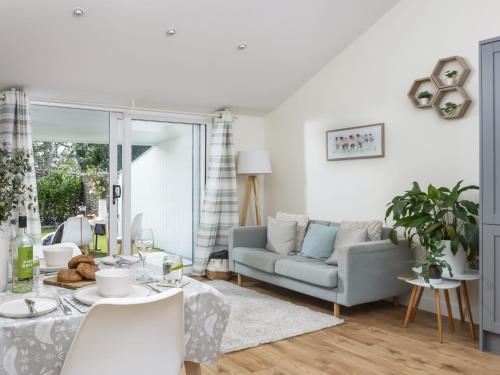 a living room with a couch and a table at Little Dunley Cottages - Willow in Bovey Tracey