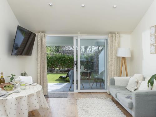 a living room with a couch and a table at Little Dunley Cottages - Maple in Bovey Tracey