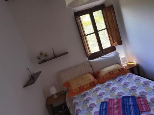 a bedroom with a bed and a window at Villa Paradiso Julia in Dicomano