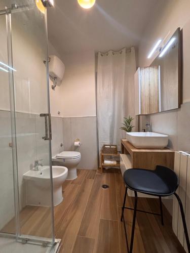 a bathroom with a toilet and a sink and a shower at De Chri House in Cisterna di Latina