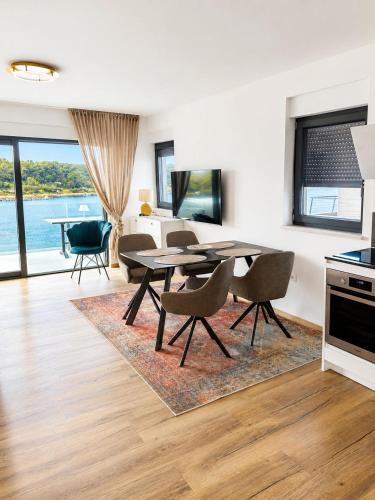 a kitchen and dining room with a table and chairs at Apartment ALBA in Medulin